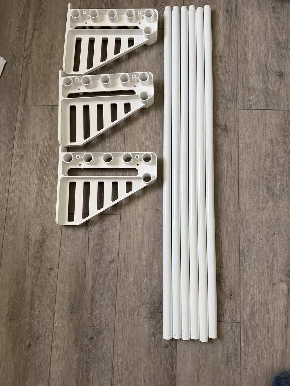 Actual XpandiShelf parts: three universal brackets and six expandable rods
