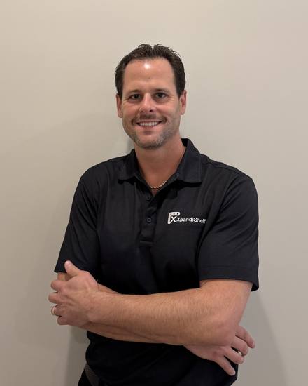 Josh, founder of XpandiShelf, wearing a black XpandiShelf polo shirt